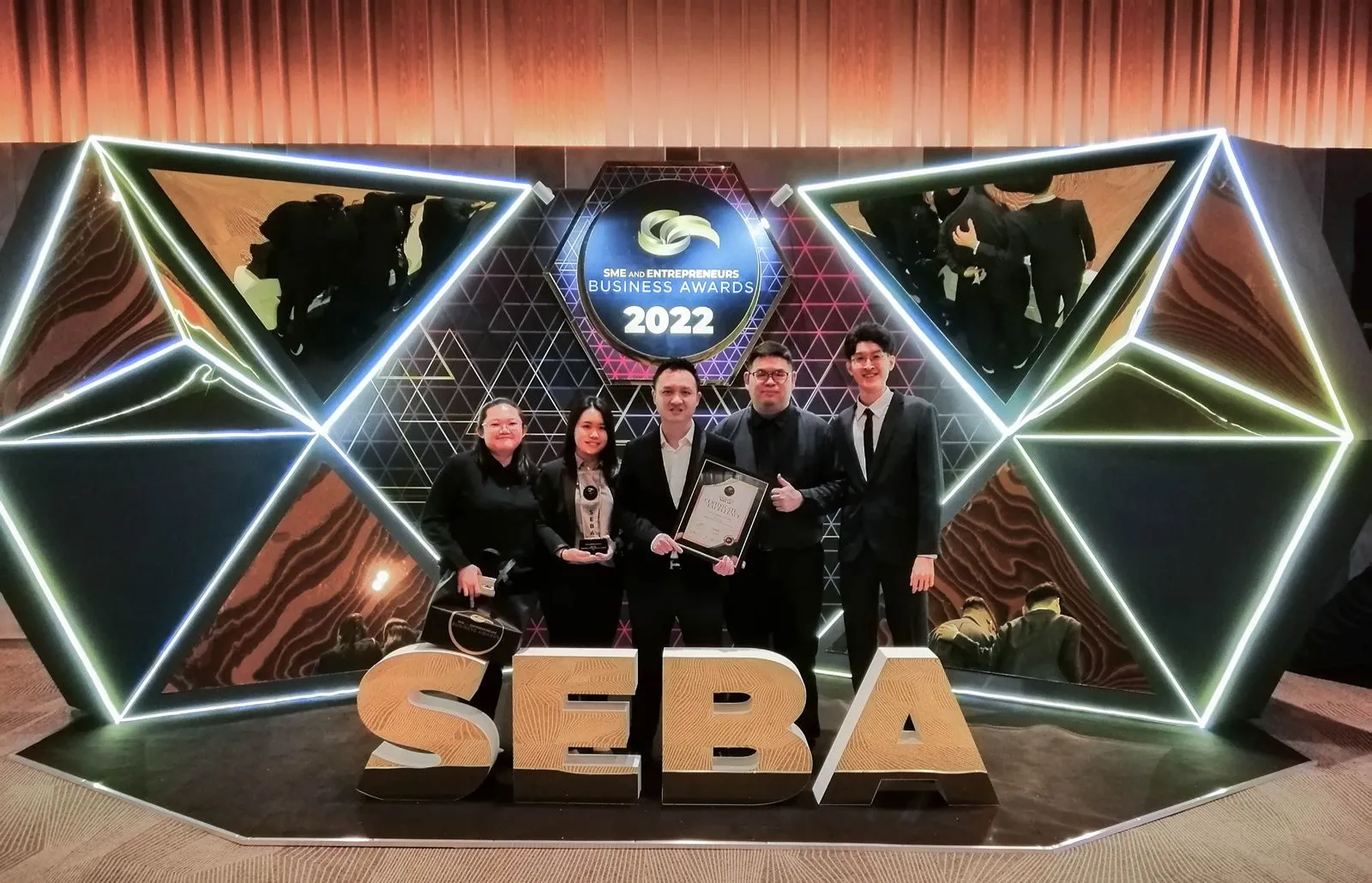 O2O Digital team with trophy and certificate at the SME and Entrepreneurs Business Awards (SEBA) 2022