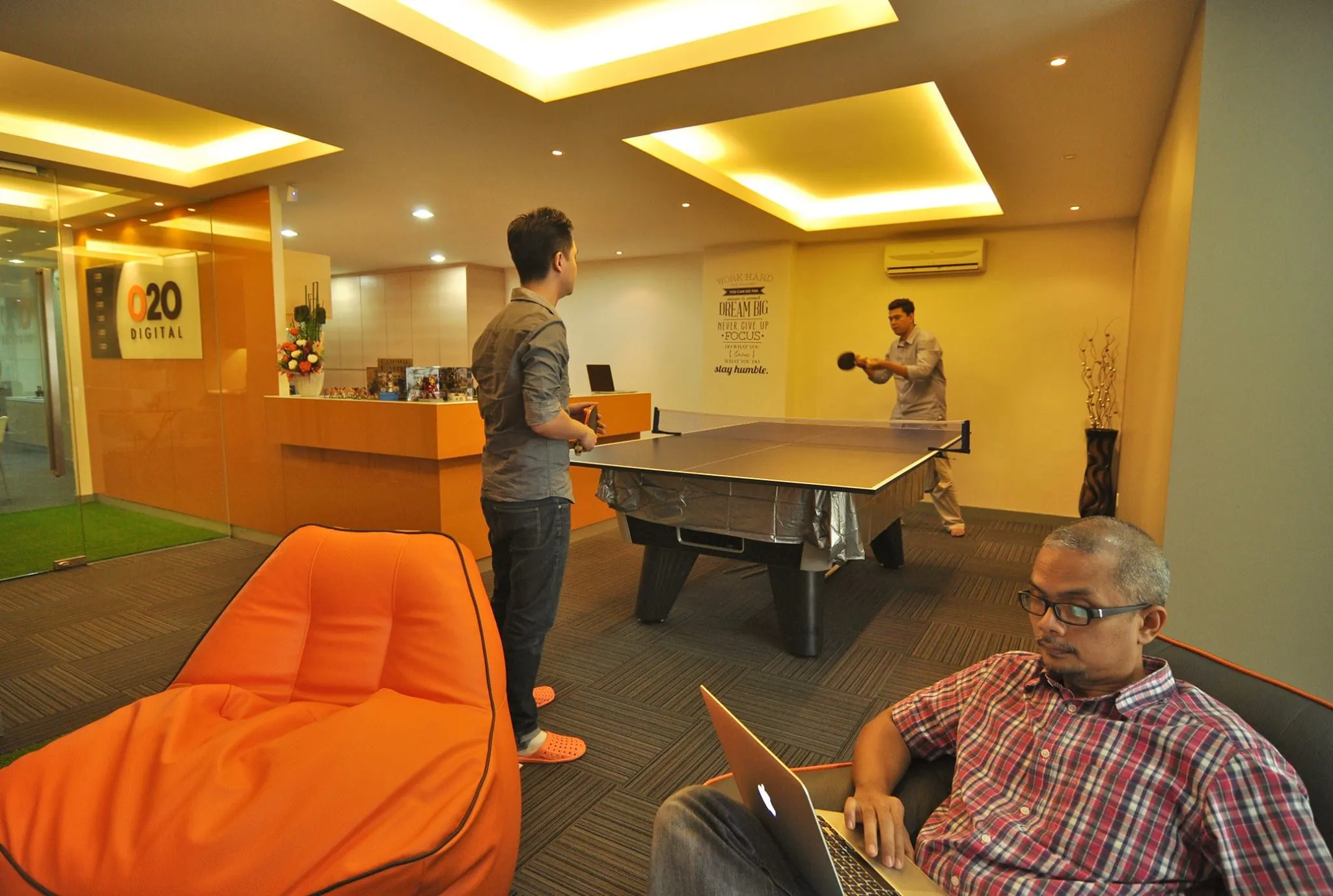 Staff playing table tennis at the O2O Digital office