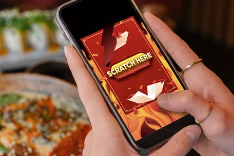 Smartphone showing a scratch-to-win online contest game